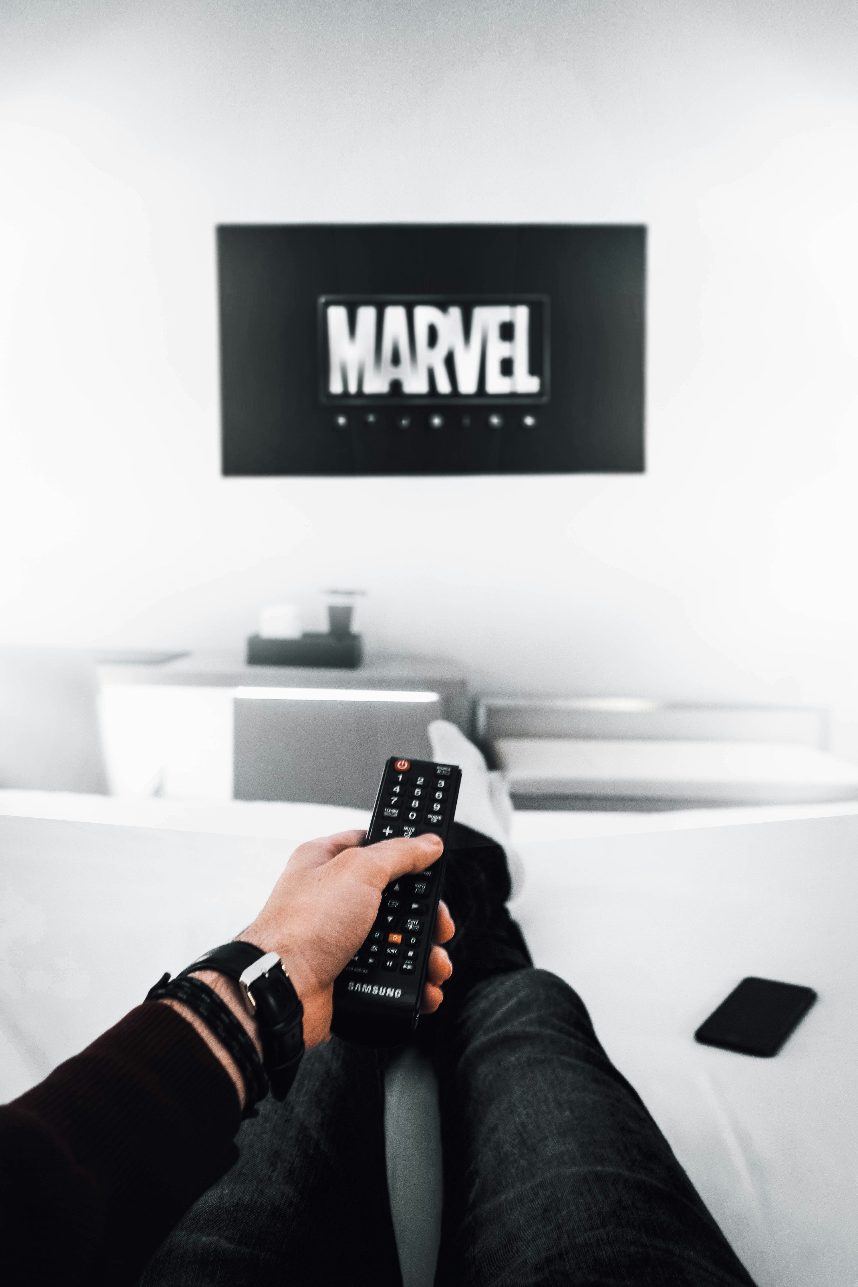 Person tittar på TV med EPG-programguide för svenska kanaler